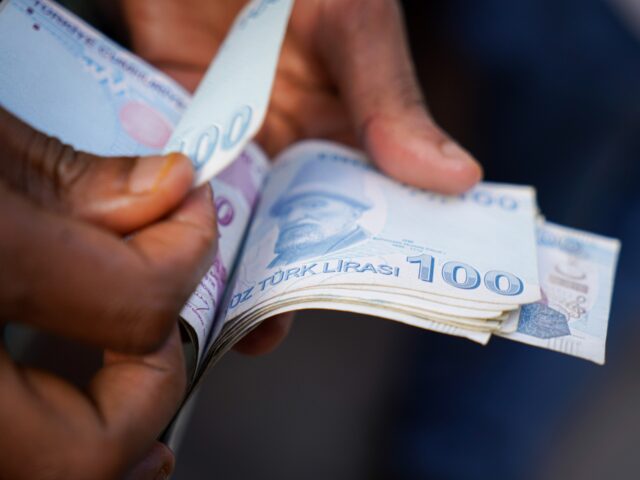 ANKARA, TURKEY - 2022/09/16: A man counts 100 Turkish lira banknotes in Ankara City. (Phot