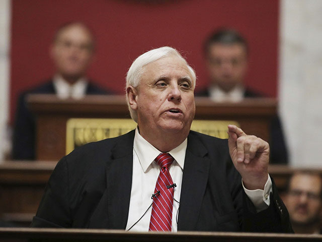 In this Wednesday, Jan. 8, 2020, file photo, West Virginia Governor Jim Justice delivers his annual State of the State address in the House Chambers at the state capitol, in Charleston, W.Va. Gov. Justice confirmed on Tuesday, June 1, 2021, that he is personally liable for $700 million in loans …
