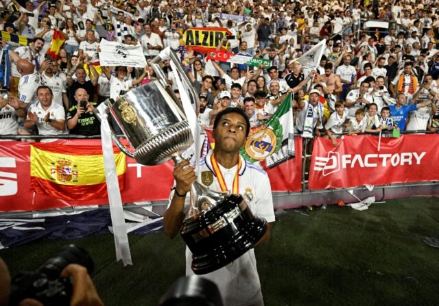 Brazilian forward Rodrygo holds the Copa del Rey trophy after helping Real Madrid beat Osa