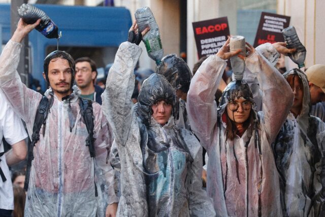 Climate protesters pour oil-like liquid over themselves outside TotalEnergies' AGM, May 20