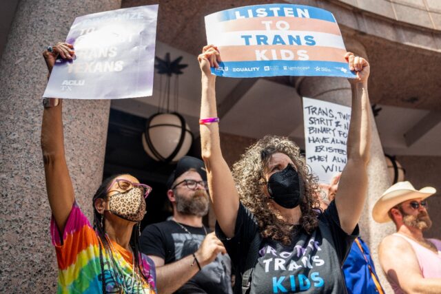Protesters rally at the Texas State Capitol on March 27, 2023 against a bill limiting heal