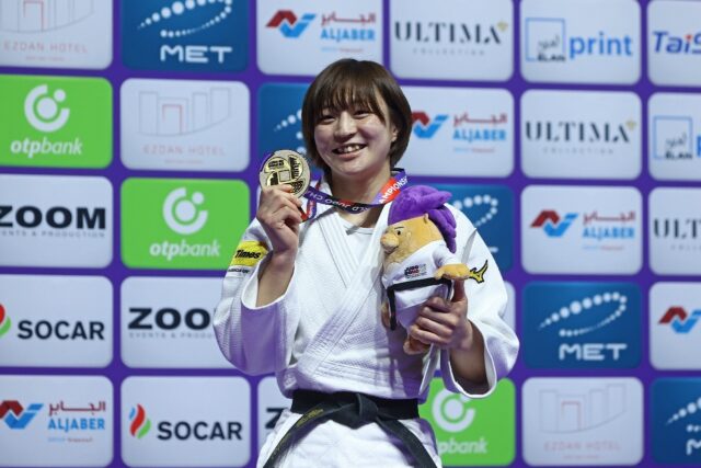 Three in a row: Japan's Natsumi Tsunoda poses with her gold medal