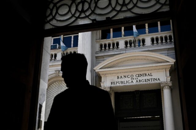 A man stands in front of Argentina's Central Bank in Buenos Aires, May 15, 2023. Year-on-y