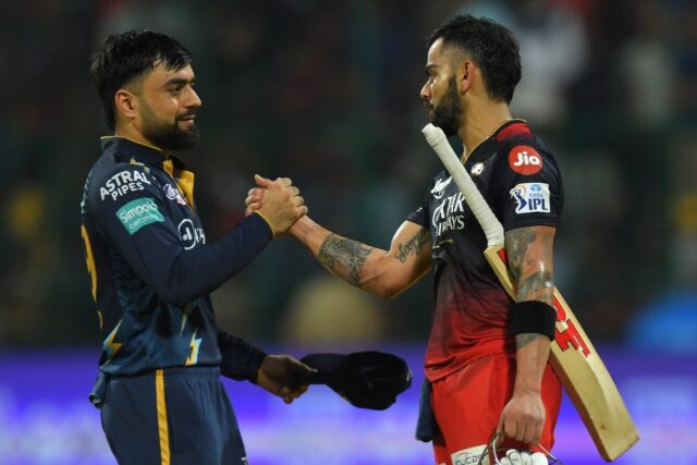 Star quality: Virat Kohli is congratulated by Gujarat's Rashid Khan after making his centu
