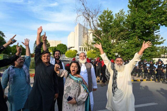 Supporters of Imran Khan's Pakistan Tehreek-e-Insaf (PTI) party chant slogans outside the