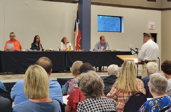 San Jacinto County Judge Fritz Faulkner reviews the county's disaster declaration prior to a unanimous vote to approve. (Bob Price/Breitbart Texas)