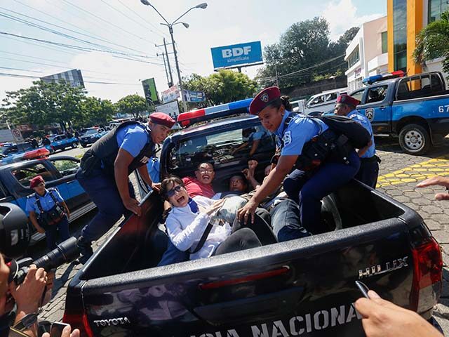 In this Sunday, Oct. 14, 2018 file photo, anti-government protesters are arrested and taken away by police as the security forces disrupt their "United for Freedom" march in Managua, Nicaragua. Anti-government protests calling for President Daniel Ortega's resignation started in April, triggered by a since-rescinded government plan to cut social …