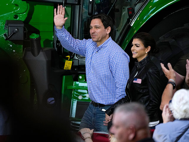 Republican presidential candidate and Florida Gov. Ron DeSantis and his wife, Casey, walk