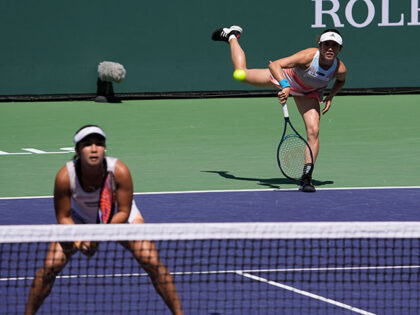 Miyu Kato, of Japan, right, serves behind her partner Aldila Sutjiadi, of Indonesia, as they play against Beatriz Haddad Maia, of Brazil, and Laura Siegemund, of Germany, in a doubles semifinal match at the BNP Paribas Open tennis tournament Friday, March 17, 2023, in Indian Wells, Calif. French Open doubles …
