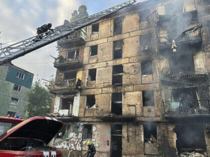 In this photo released by Dnipro Regional Administration, emergency workers extinguish a fire after missiles hit a multi-story apartment building in Kryvyi Rih, Ukraine, Tuesday, June 13, 2023. (Dnipro Regional Administration via AP)