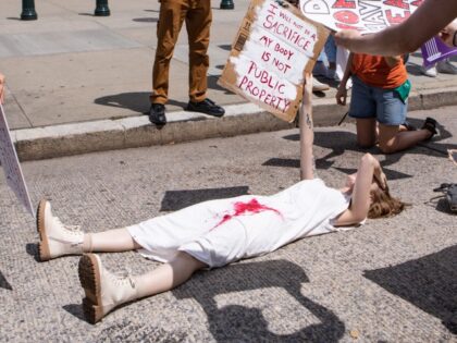 WASHINGTON, DC - JUNE 24: An abortion-rights activist lies in front of the U.S. Supreme Co