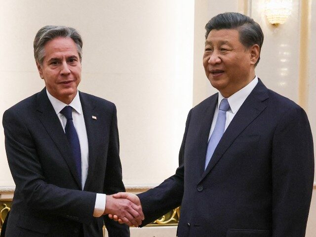 US Secretary of State Antony Blinken (L) shakes hands with China's President Xi Jinping at