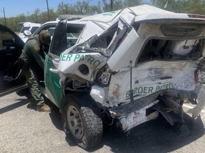 An allegedly distracted driver crashed into a Border Patrol vehicle parked at an interior