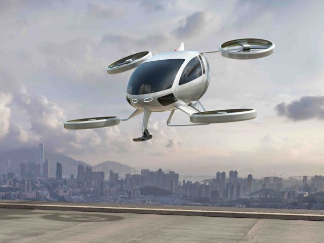 A generic white electric powered Vertical Take Off and Landing eVTOL aircraft with four ro