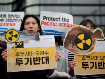 Members of civic groups hold signs during a rally to oppose Japanese government's decision to release treated radioactive water from the Fukushima nuclear power plant, near a building which houses Japanese Embassy, in Seoul, South Korea, Thursday, June 8, 2023. The letters read "Oppose to release treated radioactive water from …