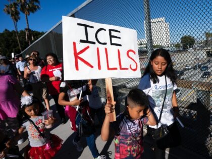 LOS ANGELES, CALIFORNIA, UNITED STATES - 2019/07/01: A child holds a placard that says ICE