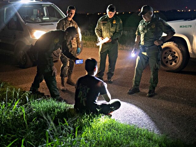 MISSION, TEXAS - SEPTEMBER 10: U.S. Border Patrol agents communicate with an undocumented immigrant from China using a smart phone translation app on September 10, 2019 in Mission, Texas. He had crossed the Rio Grande into Texas with a group earlier in the day, according to border agents who tracked …
