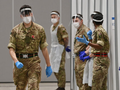 Soldiers wearing full PPE (personal protective equipment) in the form of face shields, glo