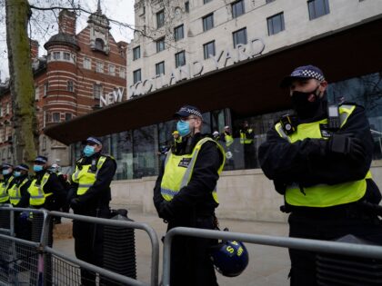 Police officers staff a cordon outside New Scotland Yard, the headquarters of the Metropolitan Police Service, as anti-lockdown protesters march against the ongoing coronavirus restrictions in central London on March 20, 2021. (Photo by Niklas HALLE'N / AFP) (Photo by NIKLAS HALLE'N/AFP via Getty Images)