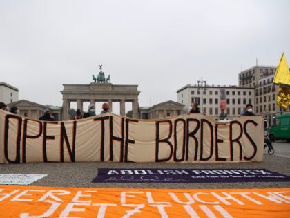 14 November 2021, Berlin: "Open the borders" is written on a banner at a demonstration for the immediate admission of migrants at the Polish-Belarusian border. Among others, the Berlin Action Alliance Against Racism, We'll Come United Berlin and Brandenburg, the Interventionist Left, Seebrücke Berlin and CoLiberation had called for the …