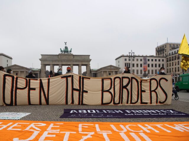14 November 2021, Berlin: "Open the borders" is written on a banner at a demonstration for