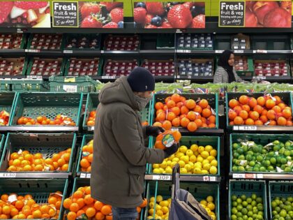 A customer shops for food items inside a Tesco supermarket store in east London on January 10, 2022. - UK annual inflation rocketed last November to 5.1 percent, more than double the Bank of England's 2.0-percent target -- price rises for fuel, clothing, food, second-hand cars and increased tobacco duty …