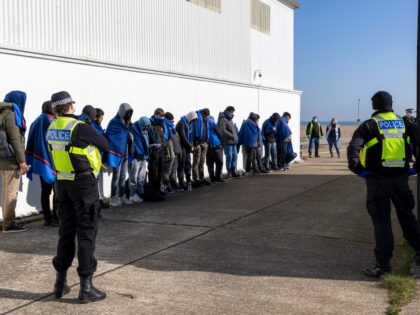 Men who have just been rescued in the channel line up to receive water and blankets outside the RNLI (Royal National Lifeboat Institution) station at Dungeness on South East Coast of Kent on the 15th of March 2022 in Dungeness, United Kingdom. There were 43 people on the RNLI boat …