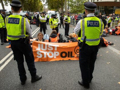 Climate activists from Just Stop Oil use glue and lock-on tubes to block the road in front