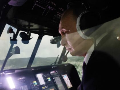 Russian President Vladimir Putin operates a Mi-171A2 helicopter flight simulator at the tr