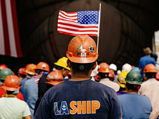 Workers during a media event for the 262-foot Eco Edison vessel while under construction a