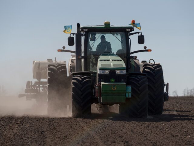 A tractor ploughs a field to plant sunflower seeds on a farm in Yemchykha, Ukraine, on Mon