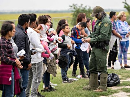 Migrants wait for a bus to take them to a processing center after turning themselves over to US Border Patrol in Fronton, Texas on May 12, 2023. The US-Mexico border appeared calm on May 12 as tough asylum rules come into force, with senior officials in Washington expressing confidence that …