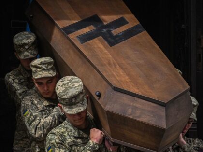 Ukrainian soldiers carry a coffin in Lviv on May 16, 2023, during funeral of Ukrainian servicemen Andriy Maltsev and Volodymyr Nestor, killed in combat with Russian troops. (Photo by YURIY DYACHYSHYN / AFP) (Photo by YURIY DYACHYSHYN/AFP via Getty Images)