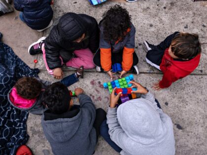 Asylum seeker children play while waiting for US Customs and Border Protection agents to allow them enter the country at the San Ysidro crossing port on the US-Mexico border, as seen from Tijuana, Baja California state, Mexico on May 31, 2023. Some 250 asylum seekers from several countries are waiting …