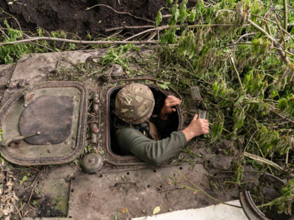 UKRAINE - 2023/05/29: Andryi, commander of self-propelled gun from 57th artillery brigade of Ukrainian Army Forces prepares to fire shell in undisclosed location of Donbas of Ukraine where this unit battles Russian invasion. 57th brigade was named after Kost Hordiyenko, Zaporozhian Cossack who was an ally of famous Ukrainian hero …