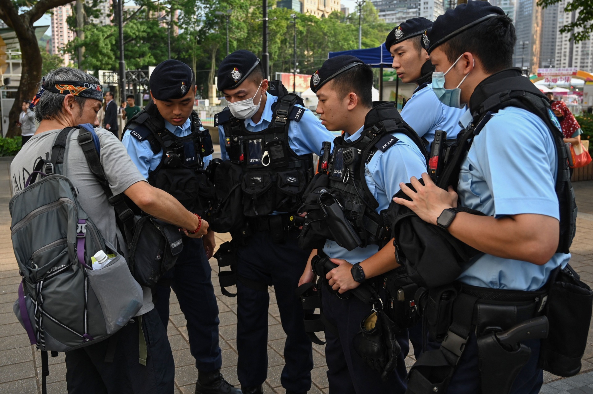 Police interrogate a local journalist at Victoria Park in Hong Kong's Causeway Bay district June 2, 2023. The park was a traditional annual gathering place for Hong Kongers to commemorate the victims of the 1989 Chinese Tiananmen Square massacre, which authorities had pledged to ban. Suppress all protests on Memorial Day.  (Photo Credit: Peter Parkes/AFP) (Photo Credit: Peter Parkes/AFP via Getty Images)