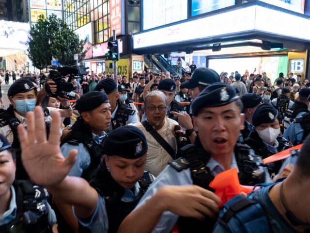 Police arrest performance artist Sanmu Chen (C) in Causeway Bay near Victoria Park in Hong Kong on June 3, 2023, a day before the anniversary of the 1989 Tiananmen Square crackdown. (Photo by Yan ZHAO / AFP) (Photo by YAN ZHAO/AFP via Getty Images)