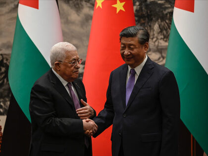 Palestinian President Mahmud Abbas shakes hands with China’s President Xi Jinping after