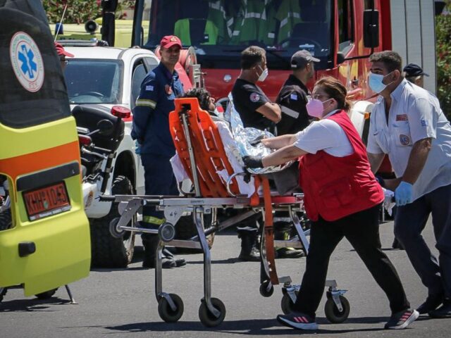 Medics transfer a survivor to an ambulance in the port of Kalamata, after a boat carrying