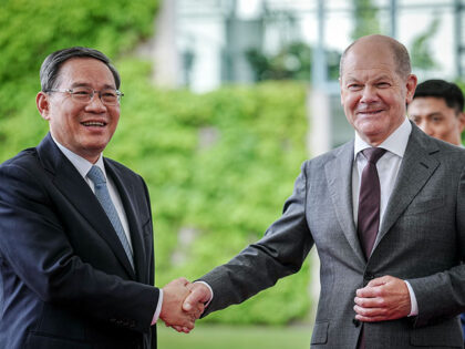German Chancellor Olaf Scholz (R) greets Chinese Premier Li Qiang upon the arrival of the