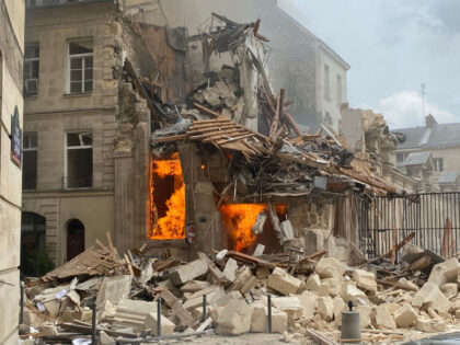 This photograph taken on June 21, 2023, shows the flames emerging from the destruction and rubble in the immediate aftermath of an explosion in a building on Rue Saint-Jacques near Place Alphonse-Laveran in the 5th arrondissement of Paris. An explosion potentially caused by a gas leak ripped through a building …
