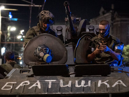 Members of Wagner group looks from a military vehicle with the sign read as "Brother" in Rostov-on-Don late on June 24, 2023. Rebel mercenary leader Yevgeny Prigozhin who sent his fighters to topple the military leaders in Moscow will leave for Belarus and a criminal case against him will be …