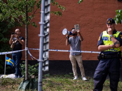 Salwan Momika protests outside a mosque in Stockholm on June 28, 2023, during the Eid al-Adha holiday. Momika, 37, who fled from Iraq to Sweden several years ago, was granted permission by the Swedish police to burn the Muslim holy book during the demonstration. (Photo by Jonathan NACKSTRAND / AFP) …