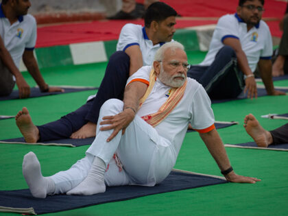 Indian Prime Minister Narendra Modi performs yoga in front of the Mysore Palace during the