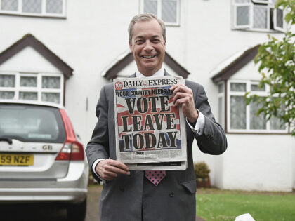 WESTERHAM, ENGLAND - JUNE 23: Nigel Farage, leader of UKIP and Vote Leave campaigner holds up the 'Daily Express' as he returns to his home after buying newspapers of the United Kingdom on June 23, 2016 in Westerham, England. The United Kingdom is going to the polls to decide whether …