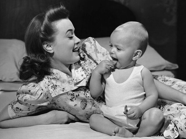 UNITED STATES - CIRCA 1950s: Mother watching baby eat cookie. (Photo by George Marks/Retrofile/Getty Images)
