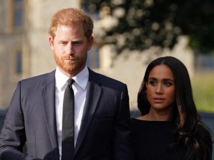 TOPSHOT - Britain's Prince Harry and Meghan, Duchess of Sussex on the long Walk at Windsor Castle on September 10, 2022, before meeting well-wishers. - King Charles III pledged to follow his mother's example of "lifelong service" in his inaugural address to Britain and the Commonwealth on Friday, after ascending …