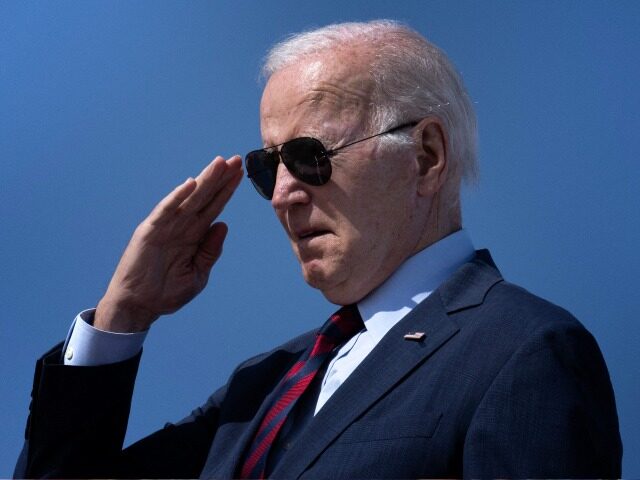 TOPSHOT - US President Joe Biden salutes while boarding Air Force One at Joint Base Andrew