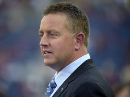 ESPN broadcaster Kirk Herbstreit watches warmups before an NCAA college football game betw
