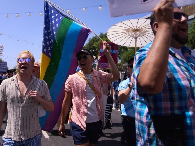 LGBTQ+ activists march during the Los Angeles LGBT Center's "Drag March LA: The March on Santa Monica Boulevard", in West Hollywood, California, on Easter Sunday April 9, 2023. - The march comes in response to more than 400 pieces of legislation targeting the LGBTQ+ community that government officials across the …